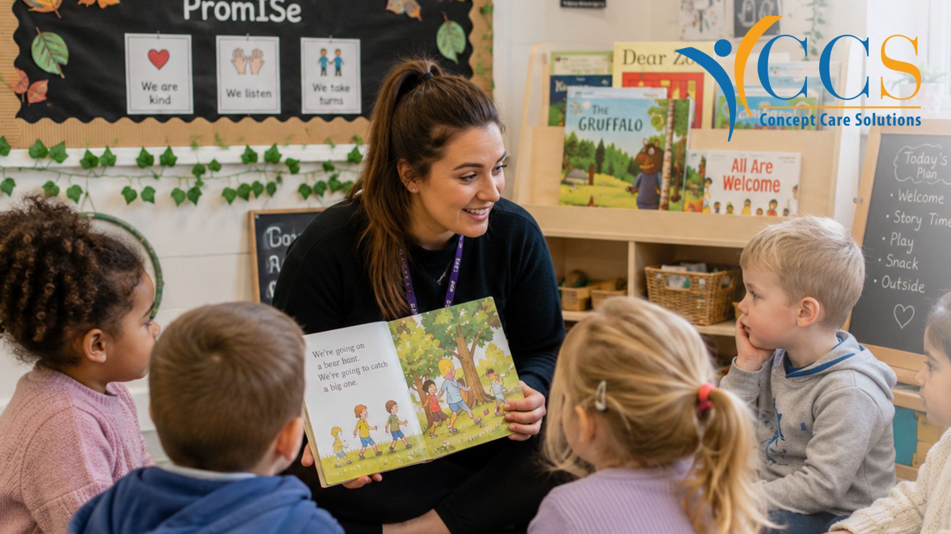 Nursery teacher reading a story to young children in a UK nursery classroom